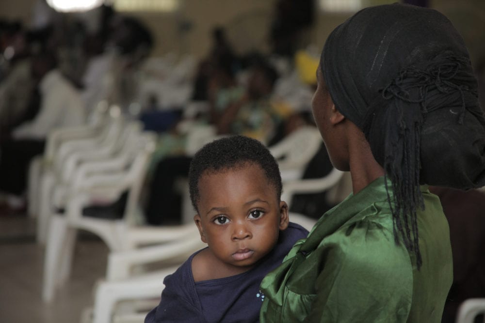 Mother watches the GLS with her child in The Gambia
