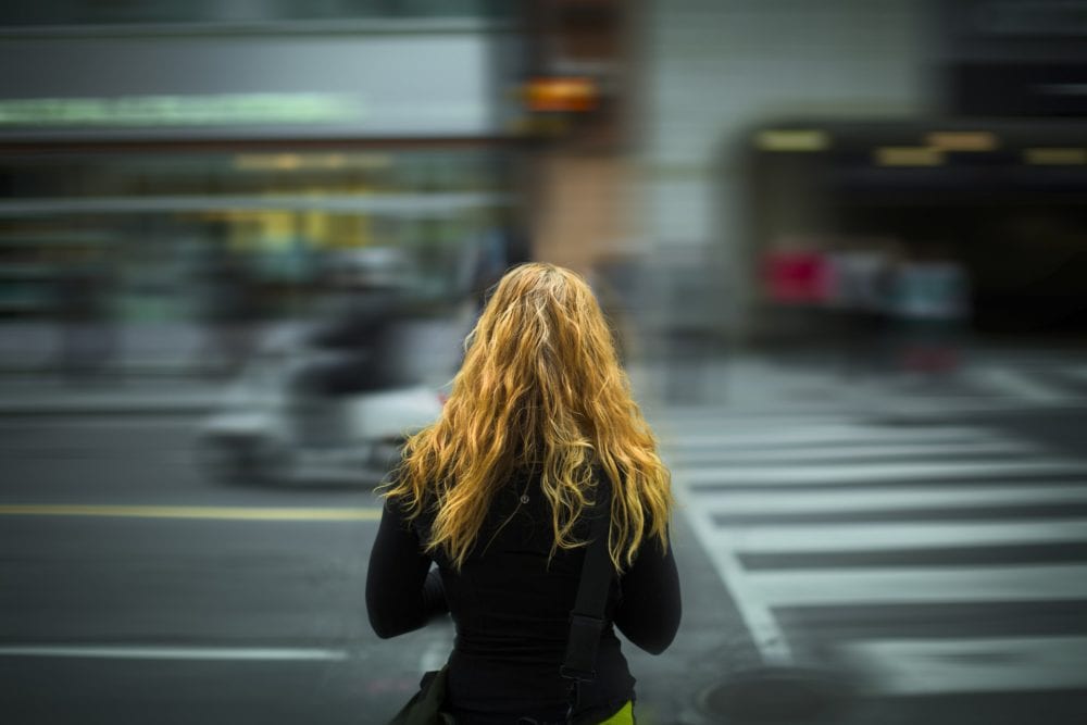 Girl standing at crosswalk