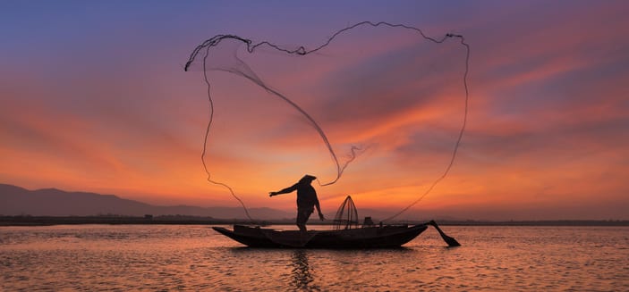 Asian fisherman with wooden boat in nature river in morning time