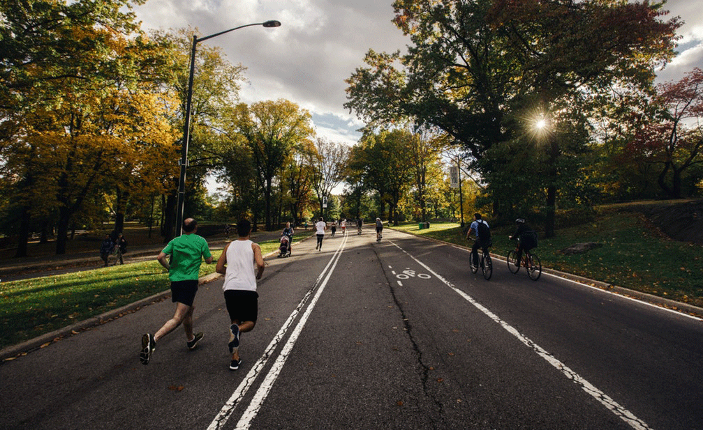 Two runners pace for a 5k race on a beautiful Saturday morning.