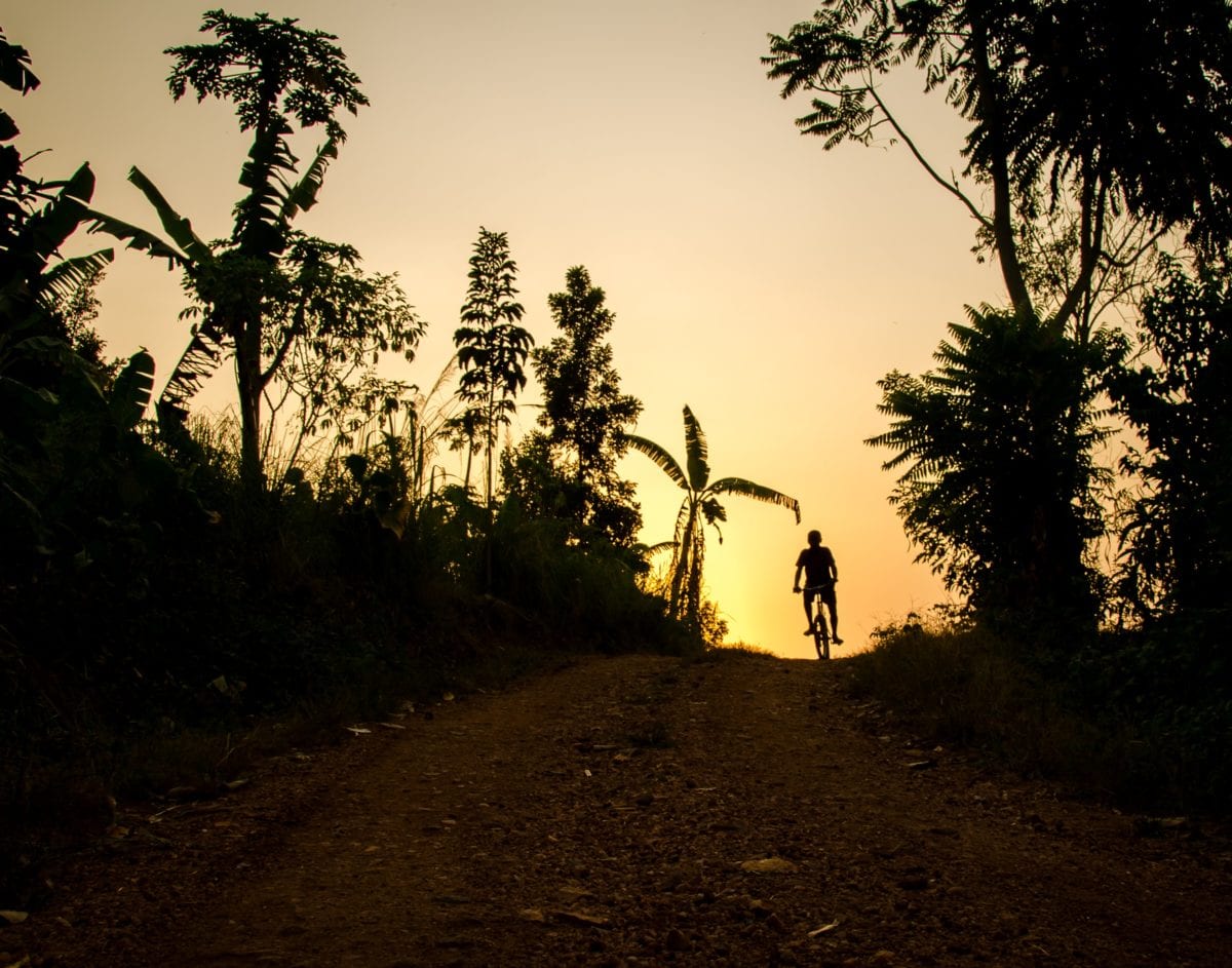 Bicycle path in Uganda against sunset