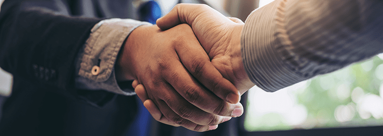 Two business workers shake hands after a negotiation.