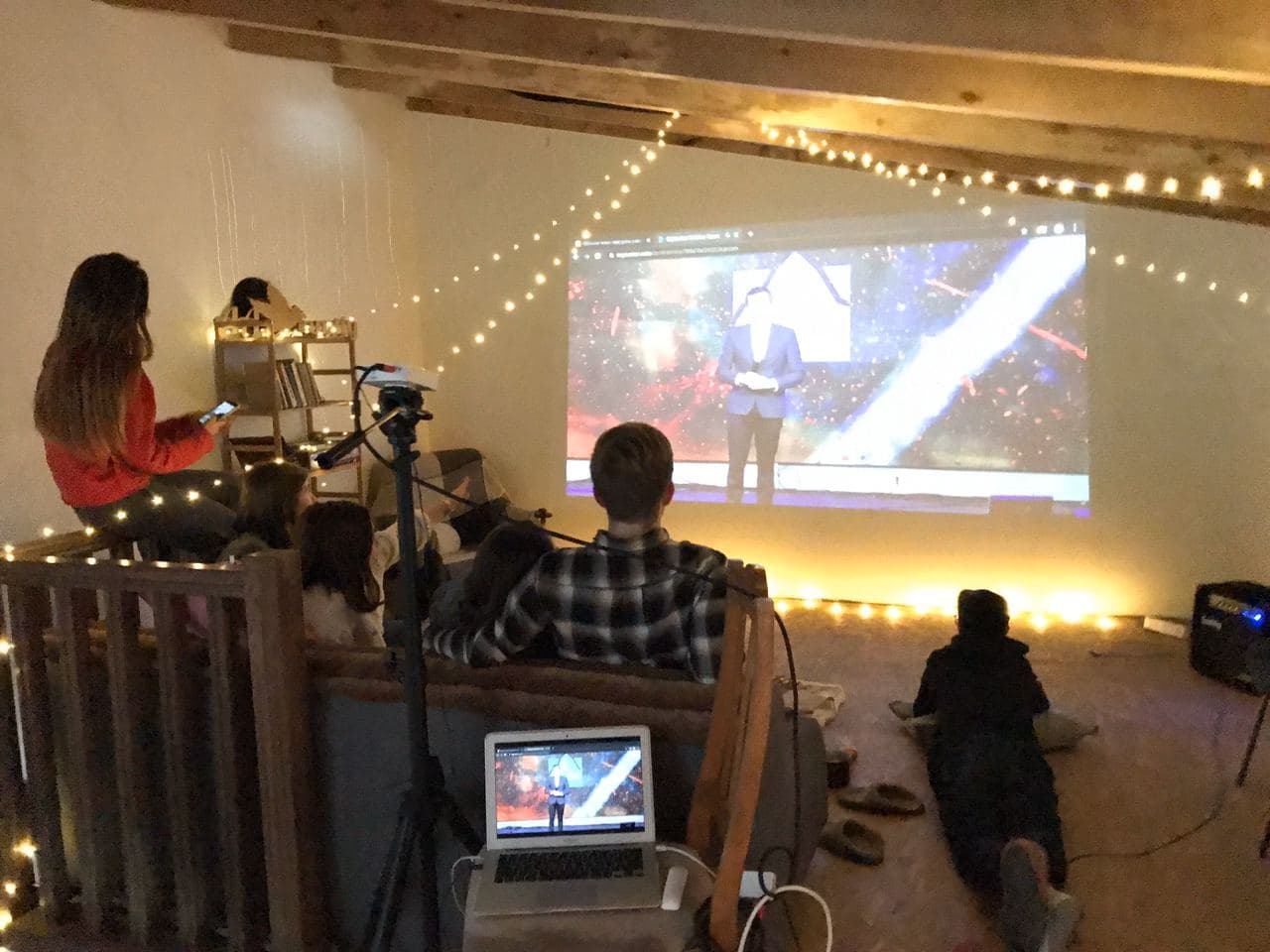 Attendees watching GLS20 via projector in a living room