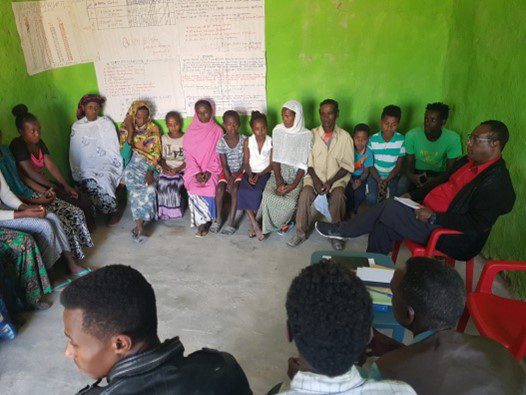 Dr. Gezahegn Asmamaw engages in community discussion to resolve local issues